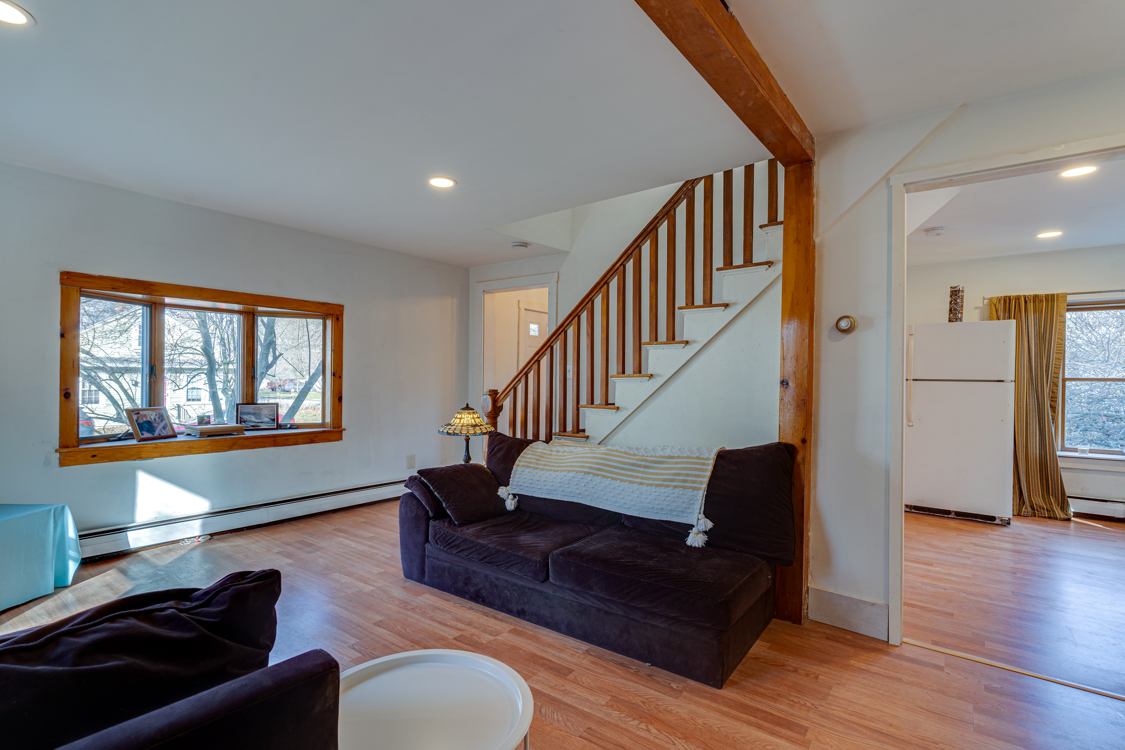 Restored 1920s staircase after hardwood tread refinishing and professional restoration.